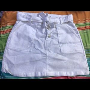 A white skirt with pockets and buttons